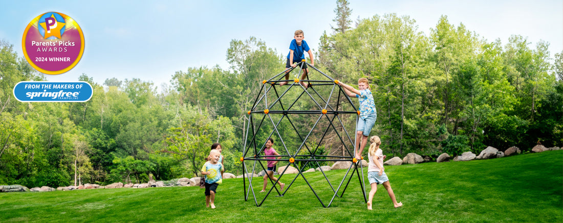 Five kids playing on and around a large geometric climbing dome.
